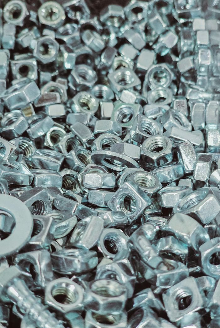 Crafting Captivating Headlines: Your awesome post title goes here Close-up view of a pile of silver metal nuts and bolts with detailed textures.