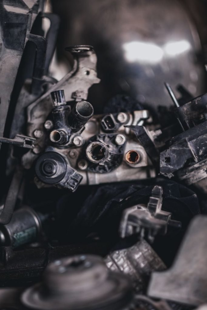 Detailed view of various disassembled engine components in an auto repair shop.