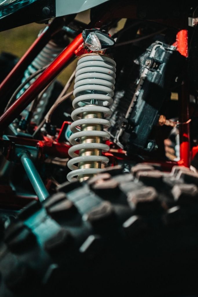 Detailed view of an ATVs coil spring suspension highlighting mechanical design and rugged build.